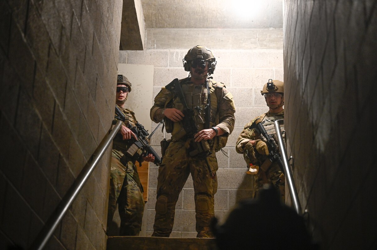 Explosive ordnance disposal (EOD) technicians and 19th Medical Group personnel secure a building during a joint EOD field training exercise at Camp Joseph T. Robinson, Arkansas, April 9, 2025. The teams operated using live explosives, allowing EOD technicians to run full mission profiles from start to finish with realistic stressors and outcomes.
