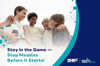 Four young children stand in a huddle, laughing and holding a soccer ball. Text reads: Stay in the Game - Stop Measles Before It Starts! Defense Health Agency and Unlock Your Health text.