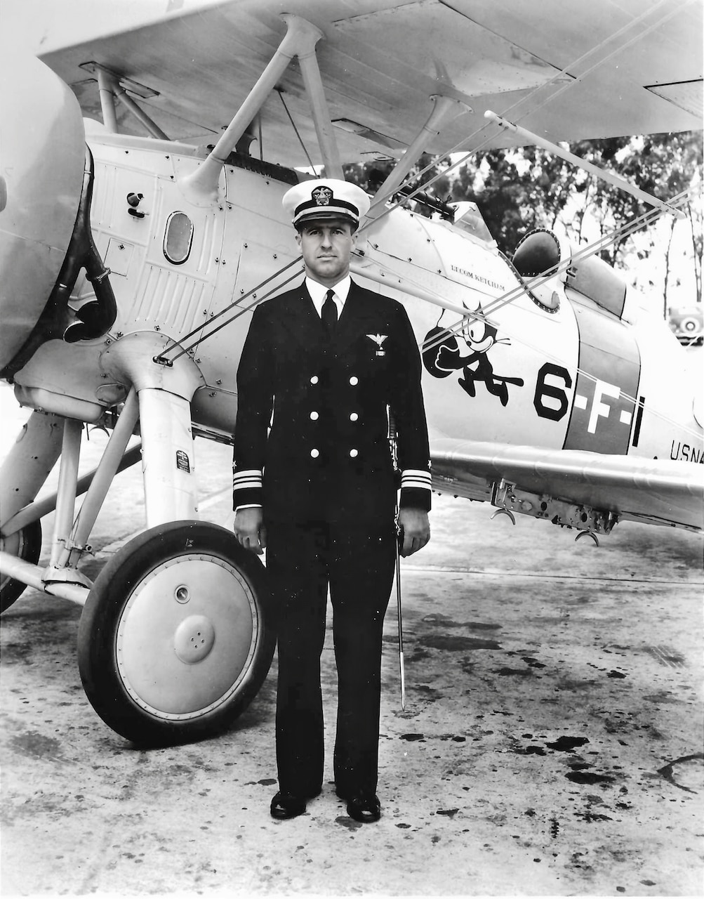 Then-Lt. Cmdr. Dixwell Ketcham (1899-1993), commanding officer of Fighting Squadron Six (VF-6), poses beside his F4B-3 at Naval Air Station San Diego in April 1936. He graduated from the U.S.  Naval Academy in 1919, and was designated a naval aviator in 1922. Note the “Felix the Cat” insignia using a popular animated cartoon character of the period. Also, the aircraft’s telescopic gunsight and its underwing bomb rack. An avid photographer, he took pictures of many subjects, including aircraft of the period as well as various cities he visited throughout his career. The photos are now the Collection of Vice Admiral Dixwell Ketcham, USN (Ret). He served throughout WWII in many senior positions lead various carrier groups and other associated Navy units.