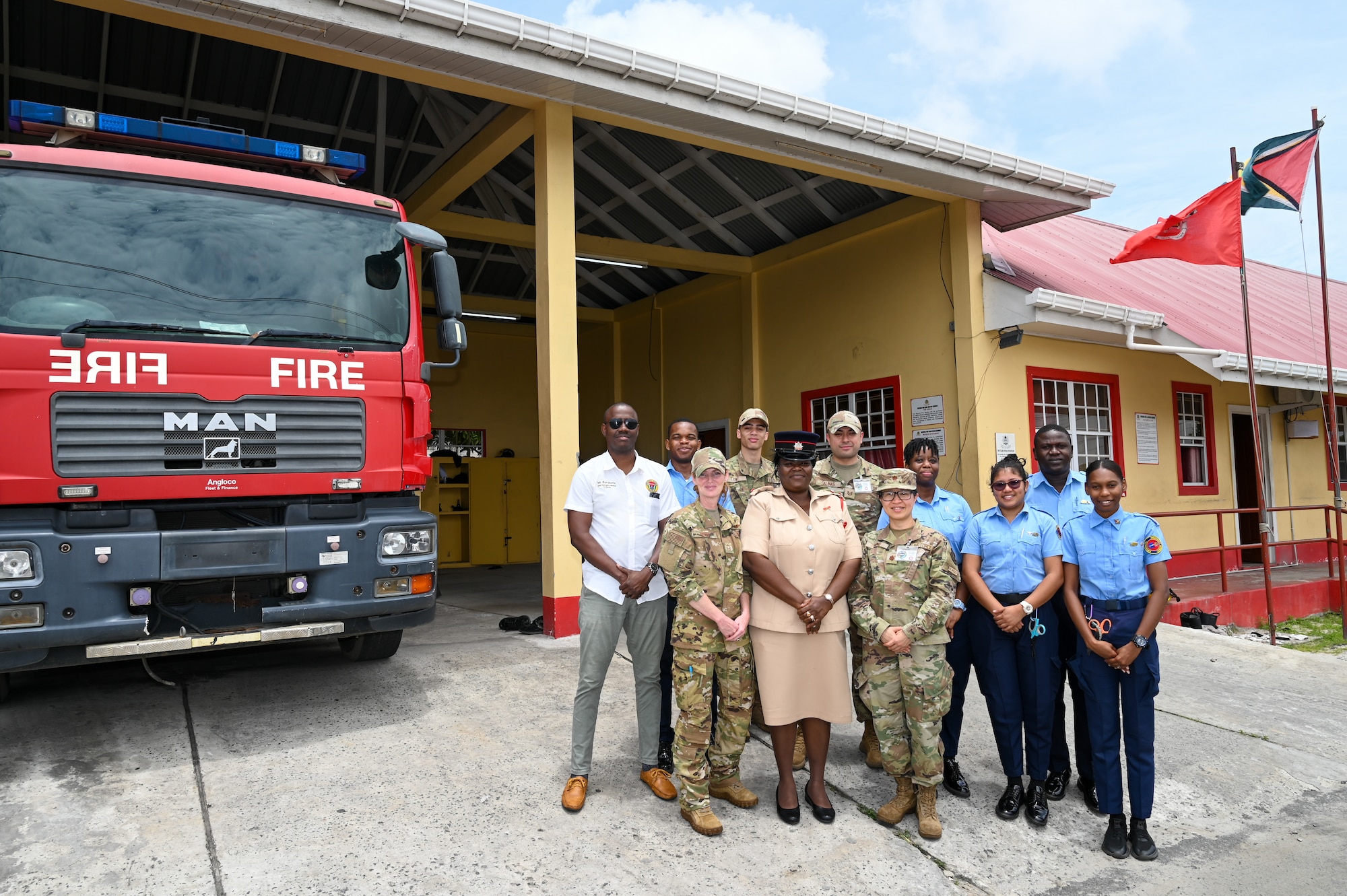 Ron Morris, chief emergency medical technician with the Guyana Emergency Medical Service; Dehola Jacobs, station officer at Eccles Fire Station; and Guyanese emergency medical technicians pose for a group photo with U.S. Air Force members from the 433rd Aeromedical Staging Squadron during a tour of the Eccles Fire Station in Georgetown, Guyana, April 2, 2025.