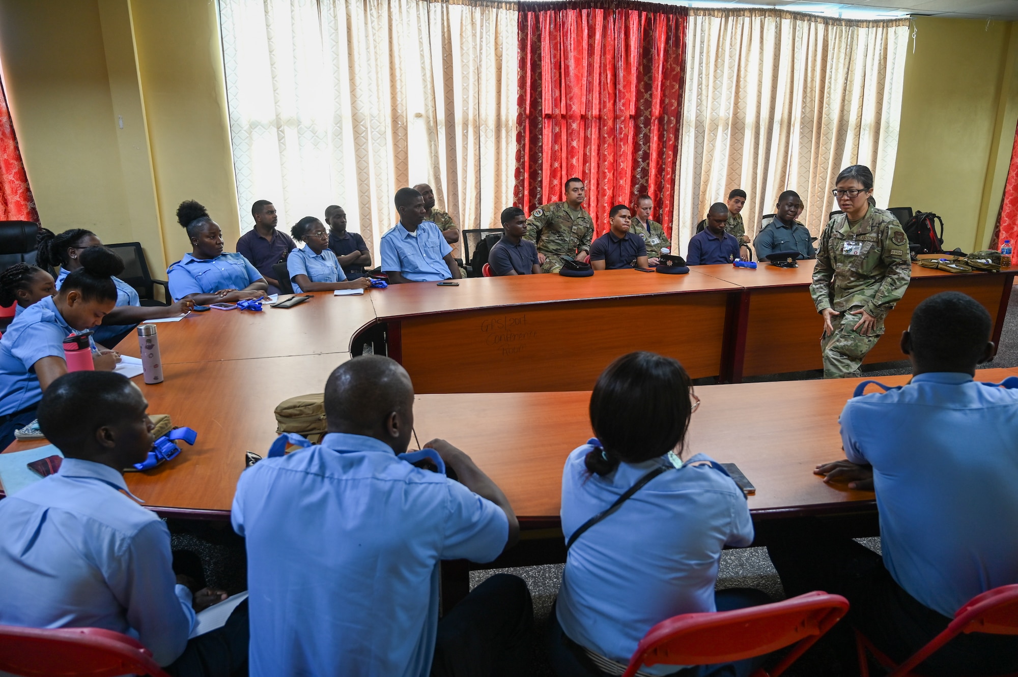 U.S. Air Force Maj. Alisha Young, a critical care air transport team physician with the 433rd Aeromedical Staging Squadron, gives a brief overview of tactical combat casualty care to Guyanese emergency medical technicians and firefighters during hands-on training at the Guyana Fire Service Headquarters in Georgetown, Guyana, April 9, 2025.
