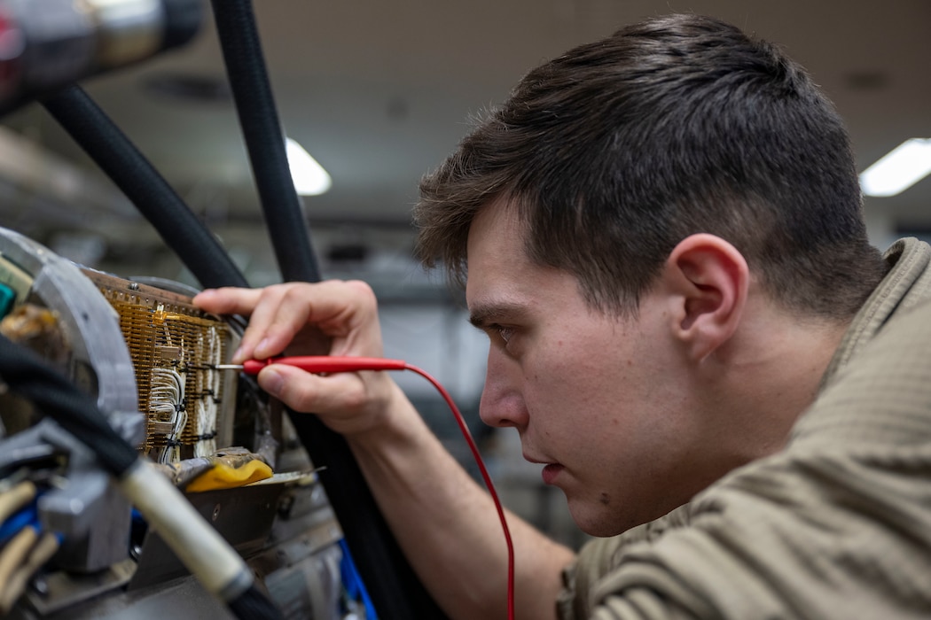 Airman working on electronics board