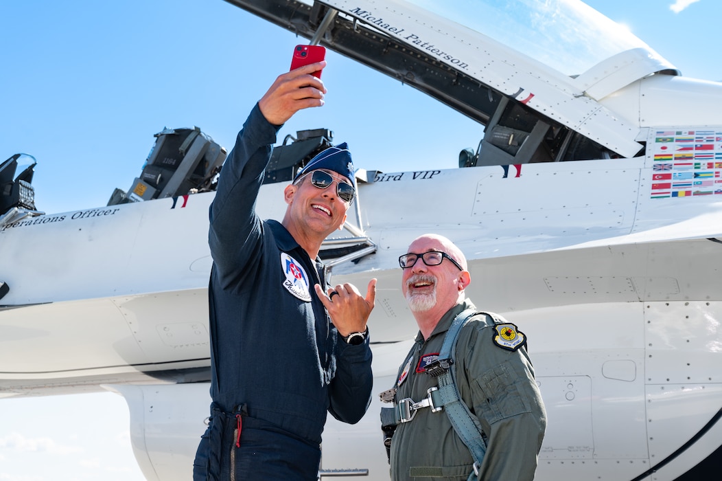Pilot and civilian taking a selfie.
