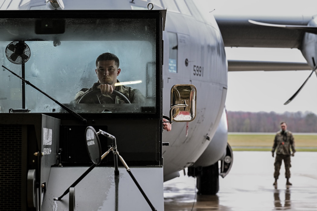 A truck towing a C-130