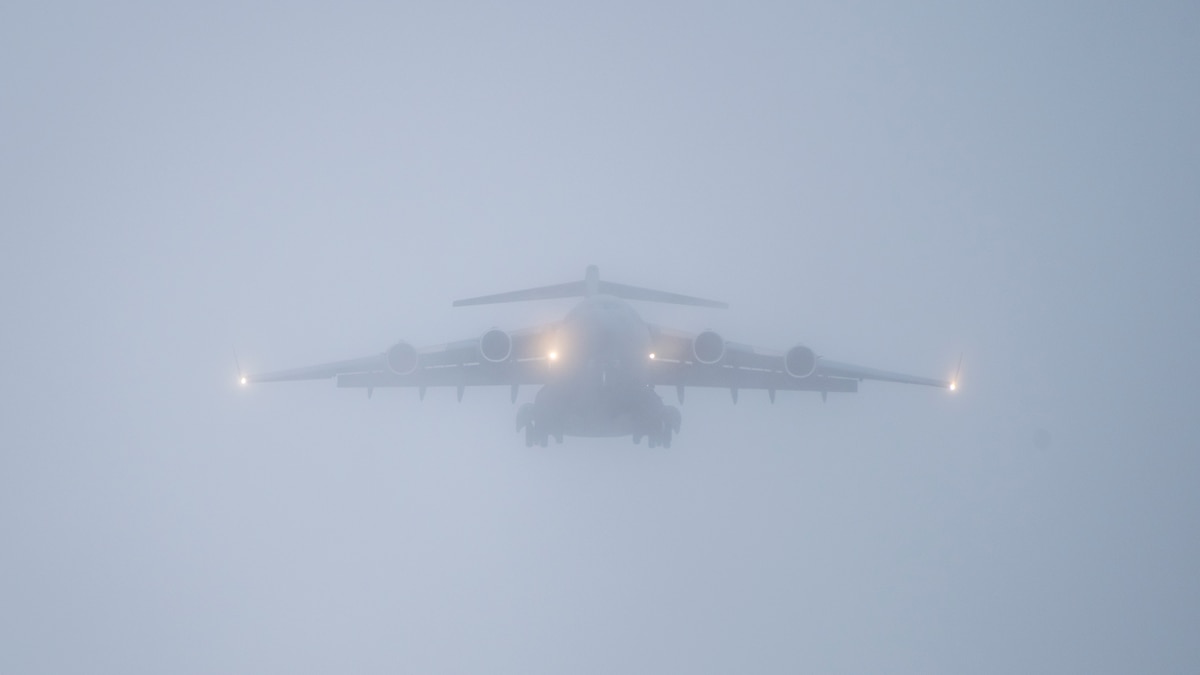 A U.S. Air Force C-17 Globemaster III assigned to the 514th Air Mobility Wing approaches the runway for landing in dense fog at John Murtha Cambria County Airport, Johnstown, Pa., April 6, 2025. With visibility severely limited, the pilots relied on advanced navigation systems and instrument landing procedures to safely descend through low cloud cover and touch down. The scenario tested the crew’s ability to operate under challenging weather conditions, enhancing readiness for real-world missions. (U.S. Air National Guard photo by Master Sgt. Bryan Hoover)