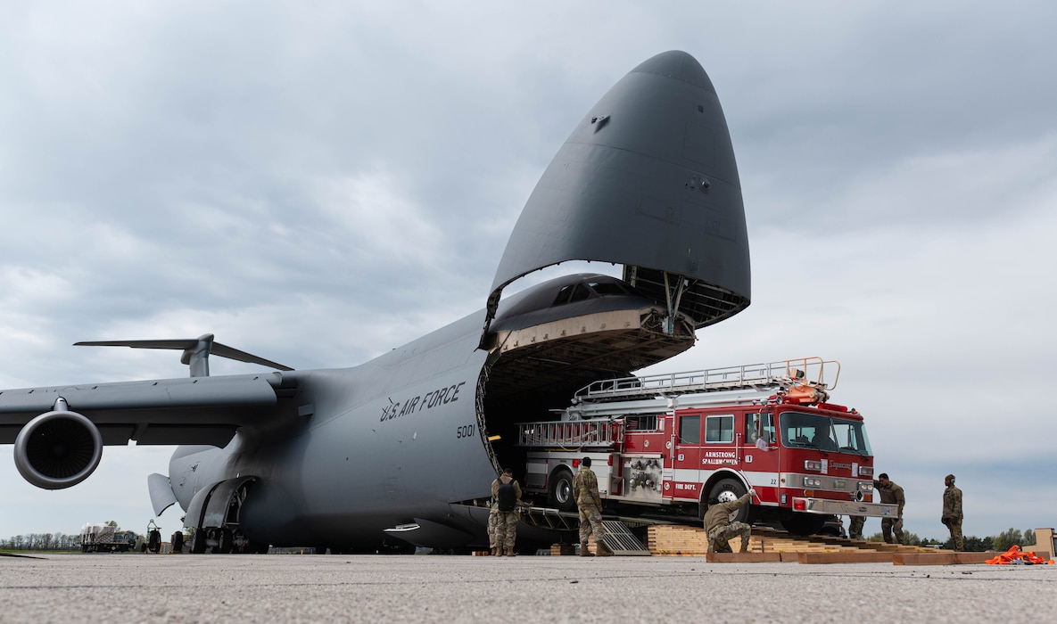 A C-5 loading a fire truck