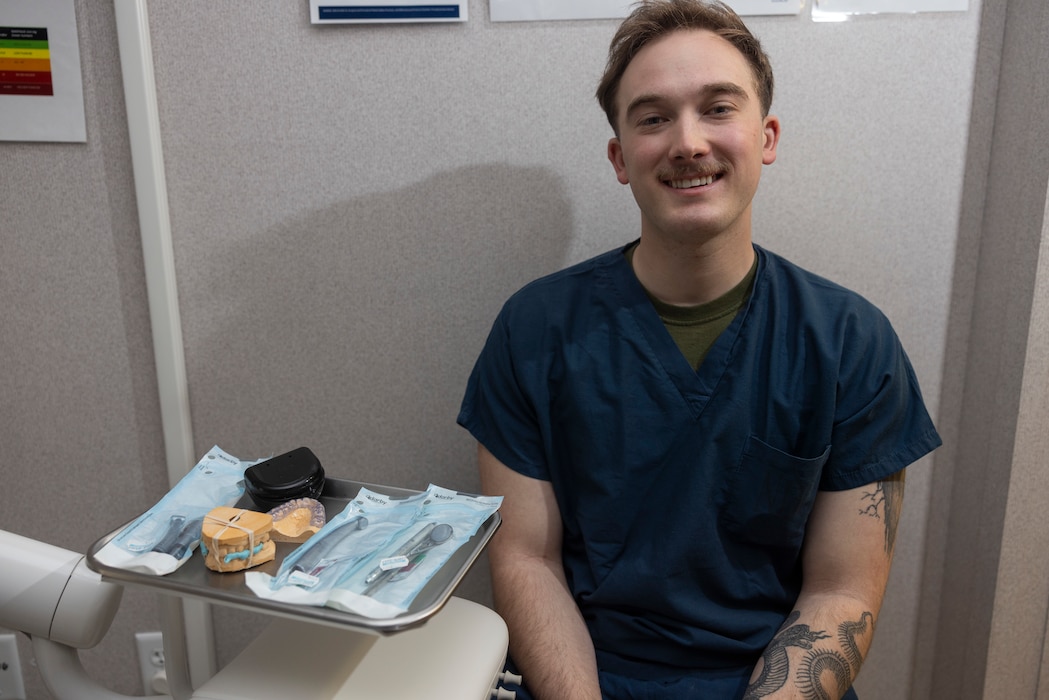 U.S. Navy Hospital Corpsman 3rd Class Carson Dunlap, a dental assistant with 2nd Dental Battalion, 2nd Marine Logistics Group, poses for a photo at the Camp Johnson Dental Clinic on Camp Gilbert H. Johnson, North Carolina, April 16, 2025. According to Dunlap's command, he was selected for Warrior of the Week for his professionalism, initiative, and excellent patient care. During his time at the Camp Johnson Dental Clinic Dunlap meticulously fabricated night guards and retainers, while also providing chairside radiologic imaging for a total of 430 patients. Dunlaps command noted that his efforts have directly contributed to a sustained operational dental readiness of 95% for the Camp Johnson Dental Clinic. Each week, 2nd MLG recognizes one outstanding Marine or Sailor that goes above and beyond in their duties and embodies the qualities of an outstanding service member. (U.S. Marine Corps photo by Cpl. Jessica J. Mazzamuto)