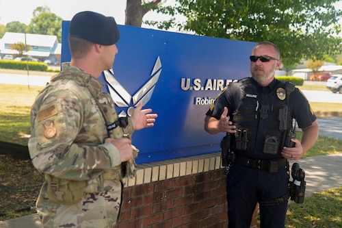 Staff Sgt. Brandon Mitchell, right, 78th Security Forces Squadron Military Working Dog kennel master, discusses dog handling tactics and techniques with Sgt. Casey Mullins, Warner Robins Police Department Proactive Crime Enforcement K-9 Unit training supervisor.