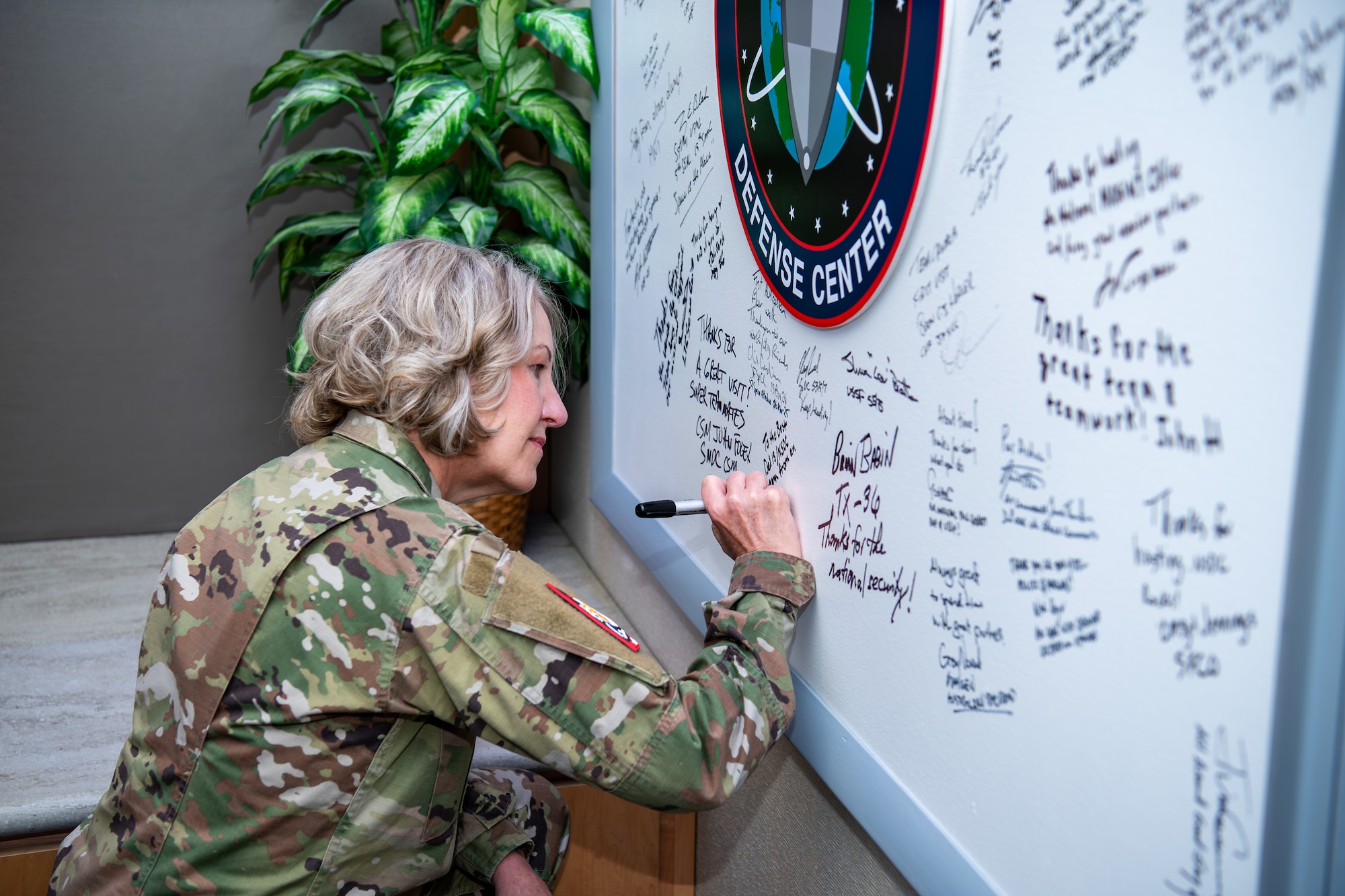 Woman in uniform signing board
