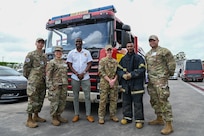 Ron Morris, Guyana Emergency Medical Service chief emergency medical technician, and a Guyana fire fighter pose for a photo with U.S. Air Force members from the 433rd Aeromedical Staging Squadron at the Guyana Fire Station Headquarters on a tour during the LAMAT mission in Georgetown, Guyana, April 2, 2025.
