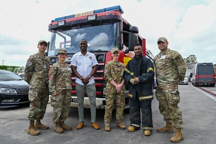 Ron Morris, Guyana Emergency Medical Service chief emergency medical technician, and a Guyana fire fighter pose for a photo with U.S. Air Force members from the 433rd Aeromedical Staging Squadron at the Guyana Fire Station Headquarters on a tour during the LAMAT mission in Georgetown, Guyana, April 2, 2025.