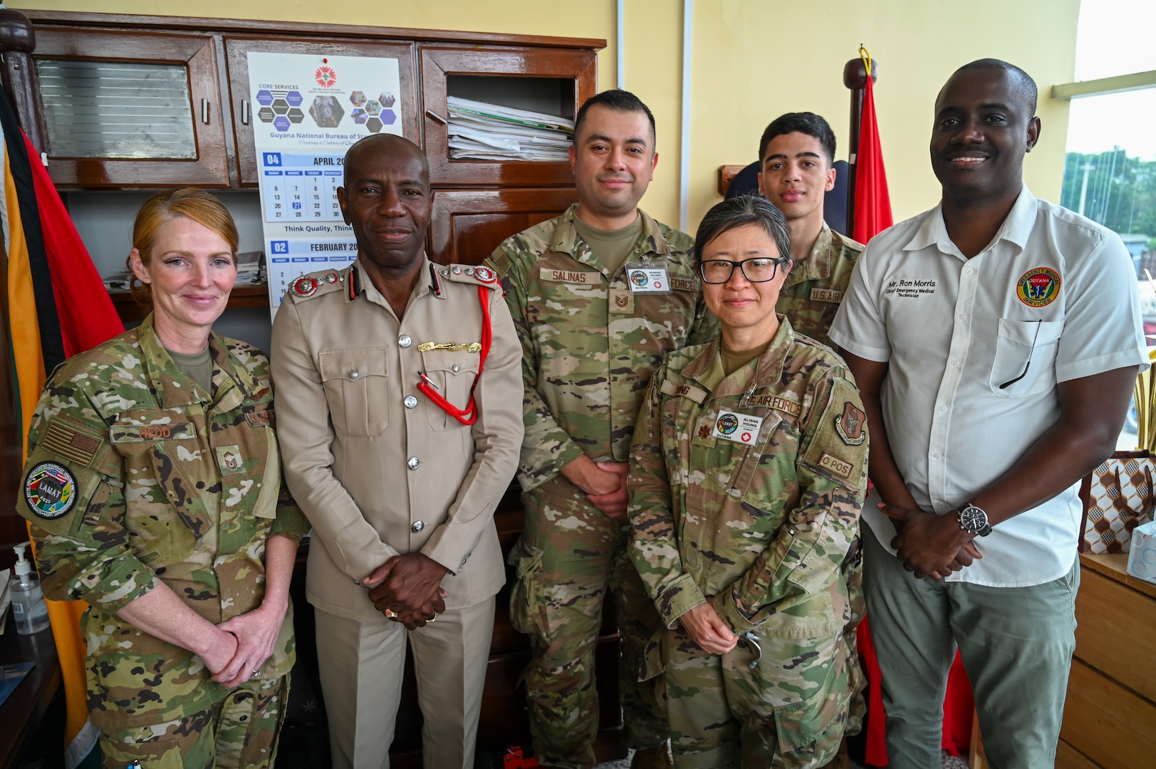 Gregory Wickham, Guyana Fire Services chief fire officer, and Ron Morris, Guyana Emergency Medical Service chief emergency medical technician, pose for a photo with U.S. Air Force members from the 433rd Aeromedical Staging Squadron at the Guyana Fire Station Headquarters on a tour during the LAMAT mission in Georgetown, Guyana, April 2, 2025.