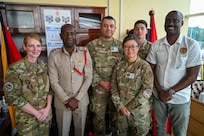 Gregory Wickham, Guyana Fire Services chief fire officer, and Ron Morris, Guyana Emergency Medical Service chief emergency medical technician, pose for a photo with U.S. Air Force members from the 433rd Aeromedical Staging Squadron at the Guyana Fire Station Headquarters on a tour during the LAMAT mission in Georgetown, Guyana, April 2, 2025.