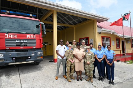 Ron Morris, chief emergency medical technician with the Guyana Emergency Medical Service; Dehola Jacobs, station officer at Eccles Fire Station; and Guyanese emergency medical technicians pose for a group photo with U.S. Air Force members from the 433rd Aeromedical Staging Squadron during a tour of the Eccles Fire Station in Georgetown, Guyana, April 2, 2025.