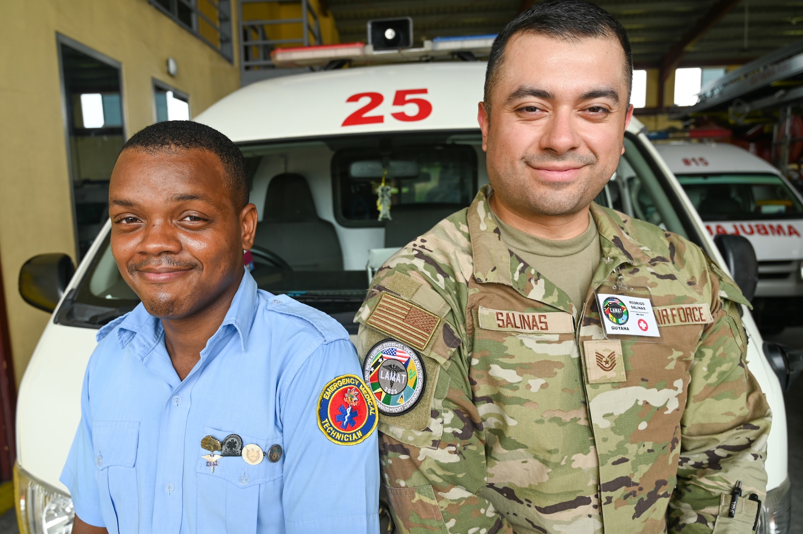 U.S. Air Force Tech. Sgt. Rodrigo Salinas, 433rd Aeromedical Staging Squadron medical technician, and Cleveland King, a Guyana Fire and Emergency Medical Service advanced emergency medical technician training officer, pose for a picture at the Guyana Fire Service Headquarters after EMT training during the Lesser Antilles Medical Assistance Team mission in Georgetown, Guyana, April 3, 2025.