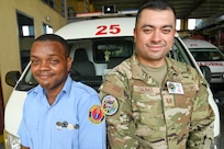 U.S. Air Force Tech. Sgt. Rodrigo Salinas, 433rd Aeromedical Staging Squadron medical technician, and Cleveland King, a Guyana Fire and Emergency Medical Service advanced emergency medical technician training officer, pose for a picture at the Guyana Fire Service Headquarters after EMT training during the Lesser Antilles Medical Assistance Team mission in Georgetown, Guyana, April 3, 2025.