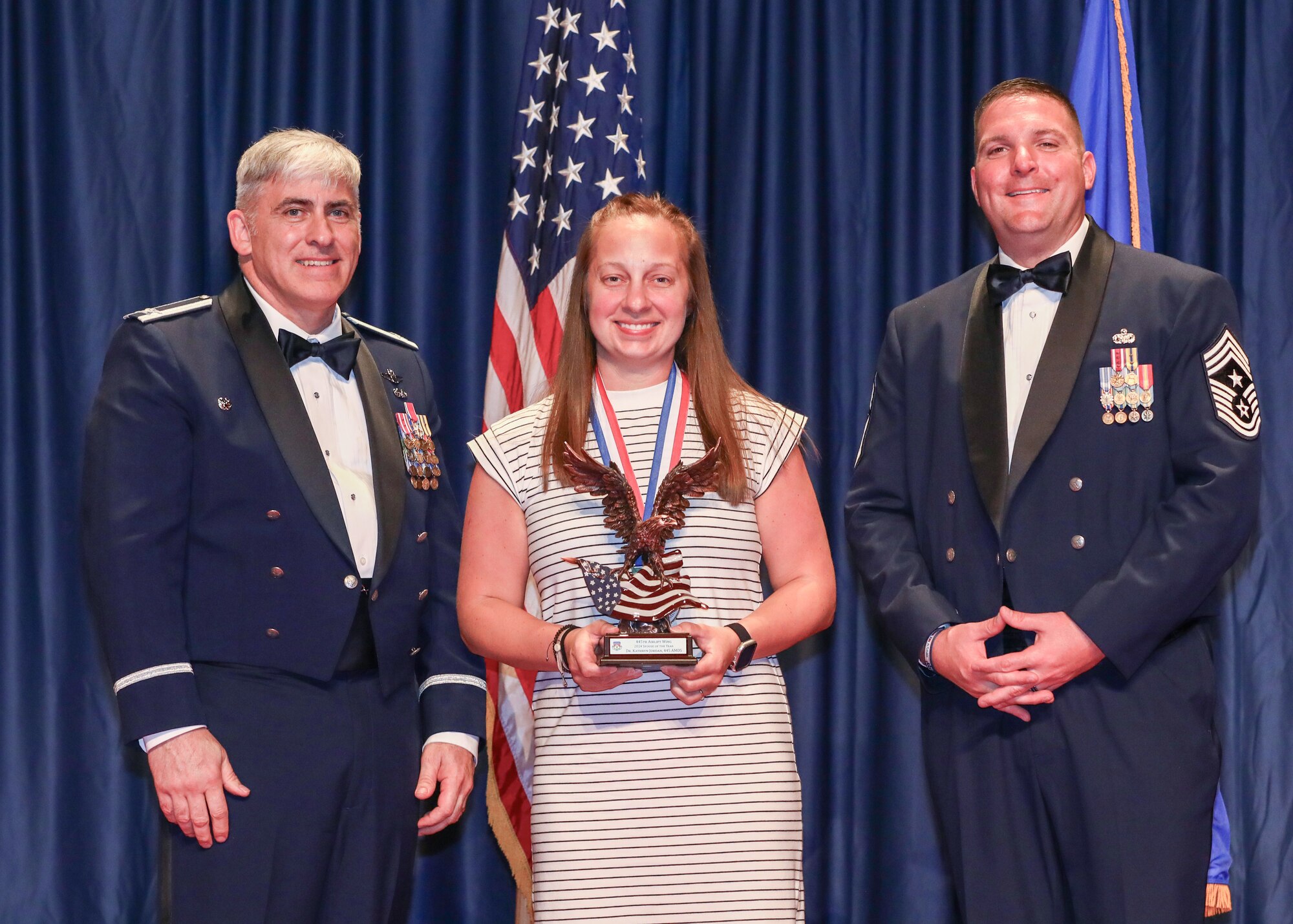 Dr. Kathryn Jordan, spouse of Tech. Sgt. Michelle Logan, 445th  
Aerospace Medicine Squadron, won the 2024 Spouse of the Year award. Members and families of the 445th Airlift Wing, and local community leaders gathered at the National Museum of the U.S. Air Force April 5 to recognize the wing’s 2024 annual award nominees and winners.