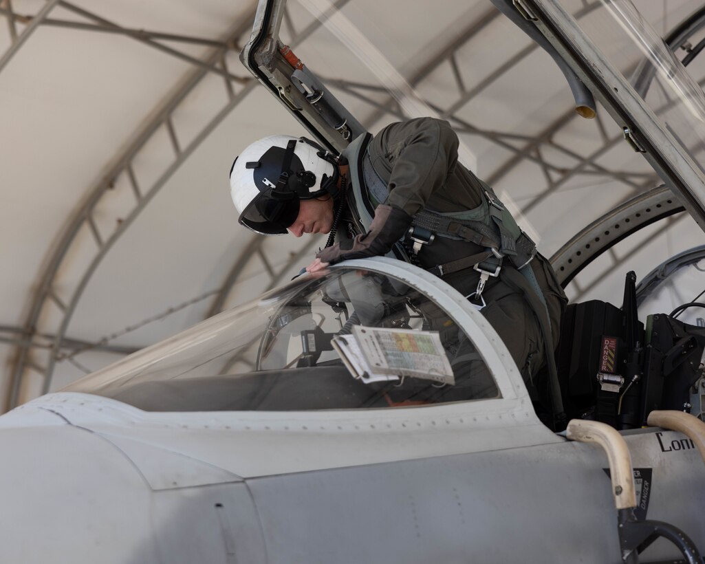 U.S. Marine Corps Lt. Col. Eric Scherrer, commanding officer, Marine Fighter Training Squadron 401 (VMFT-401), Marine Aircraft Group 41, 4th Marine Aircraft Wing, enters an F-5N Tiger II at Marine Corps Air Station Yuma, Arizona, Oct. 28, 2022. VMFT-401 is the only adversary squadron with the mission to act as the opposing force in simulated air combat. (U.S. Marine Corps photo by Lance Cpl. Jade Venegas)