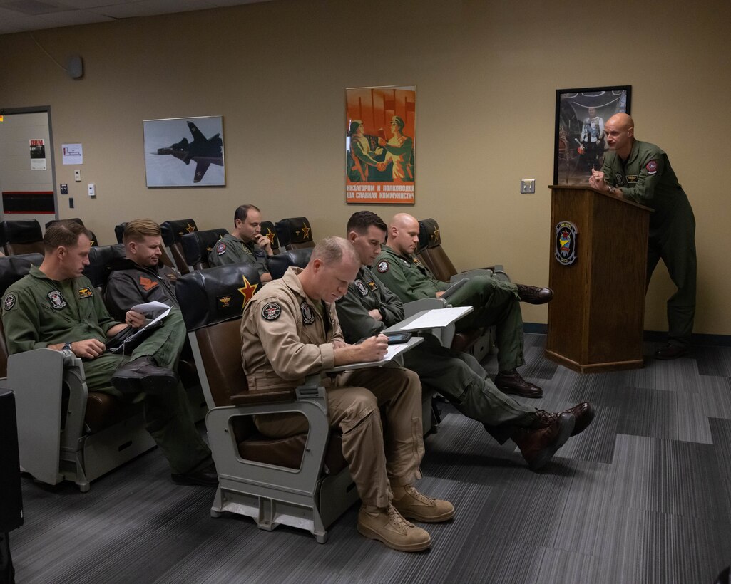 U.S. Marine Corps Lt. Col. Michael Webb, executive officer, Marine Fighter Training Squadron 401 (VMFT-401), Marine Aircraft Group 41, 4th Marine Aircraft Wing, leads a flight brief at Marine Corps Air Station Yuma, Arizona, Oct. 28, 2022. VMFT-401 is the only adversary squadron with the mission to act as the opposing force in simulated air combat. (U.S. Marine Corps photo by Lance Cpl. Jade Venegas)