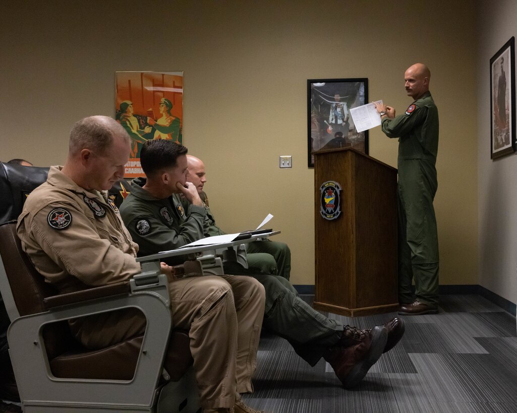 U.S. Marine Corps Lt. Col. Michael Webb, executive officer, Marine Fighter Training Squadron 401 (VMFT-401), Marine Aircraft Group 41, 4th Marine Aircraft Wing, leads a flight brief at Marine Corps Air Station Yuma, Arizona, Oct. 28, 2022. VMFT-401 is the only adversary squadron with the mission to act as the opposing force in simulated air combat. (U.S. Marine Corps photo by Lance Cpl. Jade Venegas)