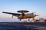 An E-2D Hawkeye from the "Seahawks" of Airborne Command and Control Squadron (VAW) 126 lands on the flight deck of the Nimitz-class aircraft carrier USS Harry S. Truman (CVN 75) during flight operations in the Atlantic Ocean in August.
