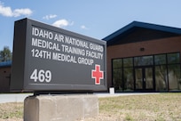 Close up image of the sign for the Idaho Air National Guard Medical Training Facility with the building seen behind it.