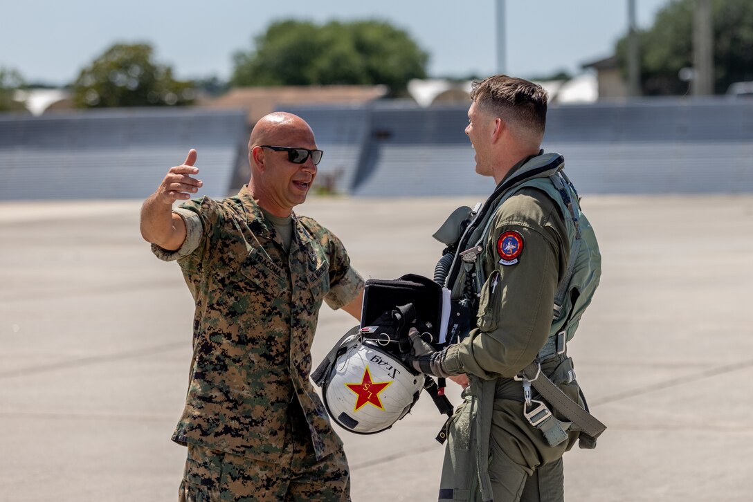 U.S. Marine Corps Master Sgt. Jason Tracoma, senior enlisted advisor, Marine Fighter Training Squadron (VMFT) 402, Marine Aircraft Group 41, 4th Marine Aircraft Wing, greets Maj. Erin Mathis, operations officer, VMFT-402, after delivering three F-5N Tiger IIs to Marine Corps Air Station Beaufort, South Carolina, May 30, 2024. VMFT-402 will be the Marine Corps’ second adversary squadron and will officially be redesignated in Sept. (U.S. Marine Corps photo by Lance Cpl. Kyle Baskin)