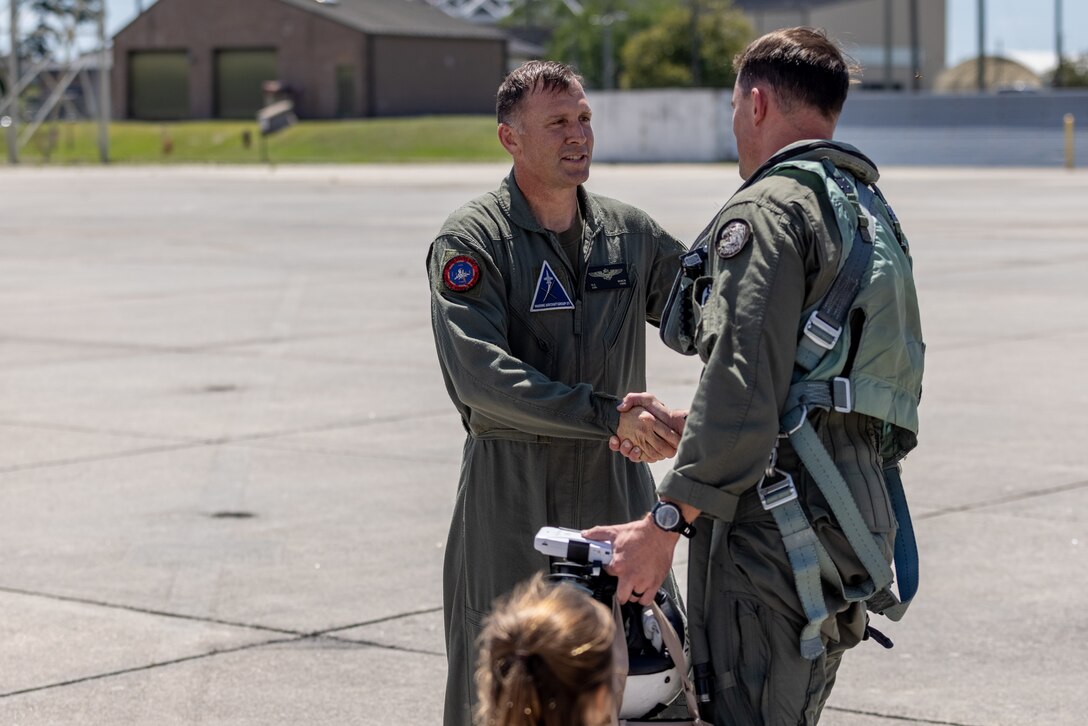 U.S. Marine Corps Col. Dustin Byrum, commanding officer, Marine Aircraft Group (MAG) 31, 2nd Marine Aircraft Wing, greets Lt. Col. Andrew Christ, commanding officer, Marine Fighter Training Squadron (VMFT) 402, MAG-41, 4th Marine Aircraft Wing, at Marine Corps Air Station Beaufort, South Carolina, May 30, 2024. VMFT-402 will be the Marine Corps’ second adversary squadron and will officially be redesignated in Sept. (U.S. Marine Corps photo by Lance Cpl. Kyle Baskin)