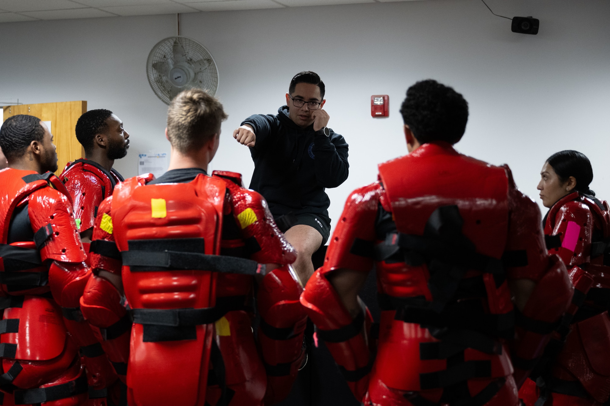 The Red Men are instructed in how to participate in the Red Man training exercise.