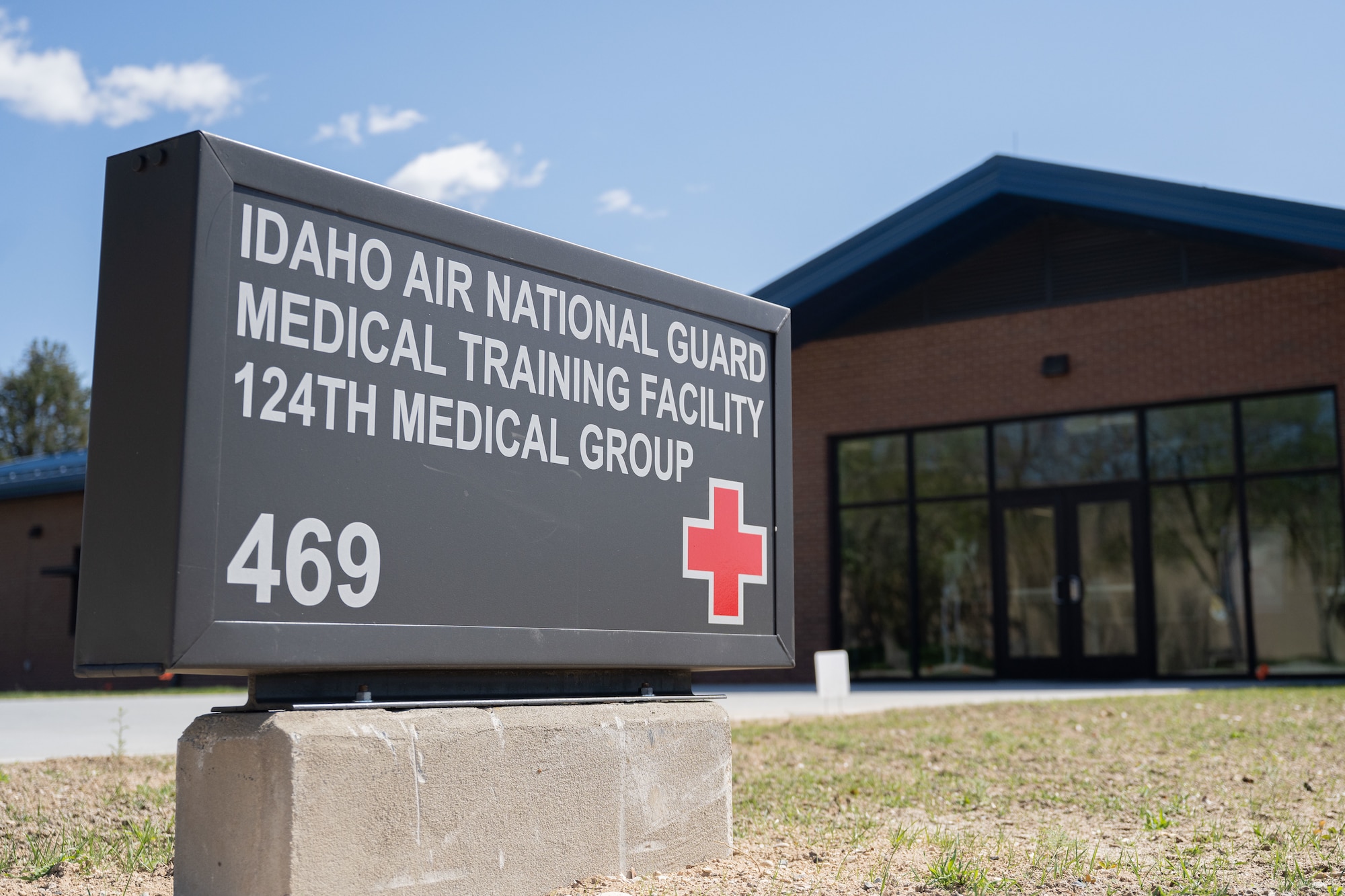 Close up image of the sign for the Idaho Air National Guard Medical Training Facility with the building seen behind it.