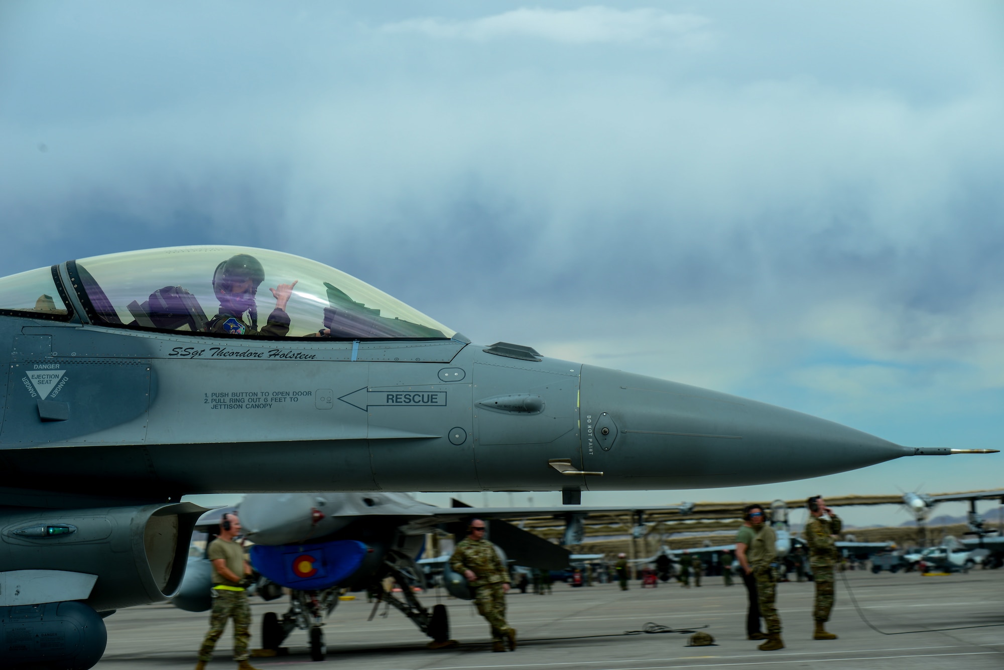 U.S. Air Force Capt. Cody “Mojo” Vanbeek, pilot, 140th Wing, Colorado Air National Guard, signals “Hang loose” to the 140th maintenance crew of Red Flag at Nellis Air Base, Las Vegas, Nevada March 11, 2025.
