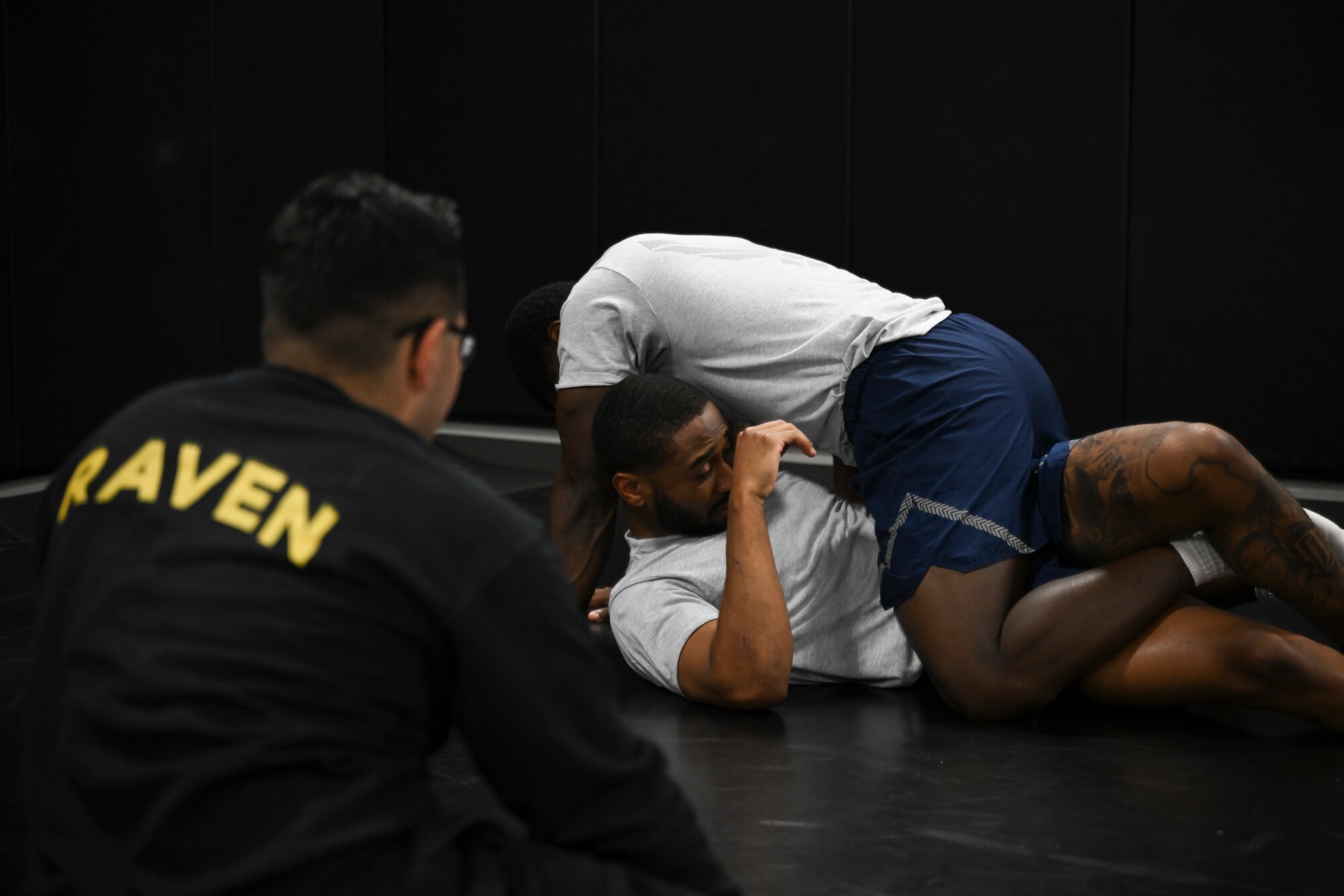 U.S. Air Force Senior Airman Dayshus White and Senior Airman Larry Ruck-Young, both protective services specialists assigned to the 816th Security Forces Squadron, grapple during the Pre-Raven course at Joint Base Andrews, Md., April 14, 2025. The instructors coached candidates through various control and escape techniques to prepare them for the Phoenix Raven qualification. (U.S. Air Force photo by Senior Airman Gianluca Ciccopiedi)