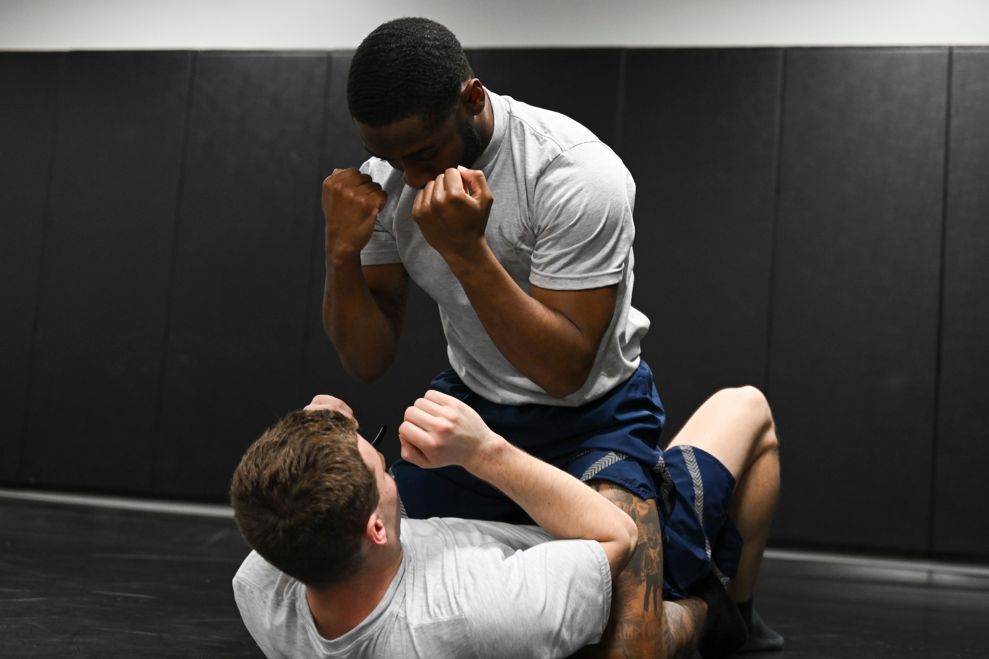 U.S. Air Force Senior Airman Larry Ruck-Young and Airman 1st Class Jared George, both protective services specialists assigned to the 816th Security Forces Squadron, grapple during the Pre-Raven course at Joint Base Andrews, Md., April 14, 2025. The course prepares candidates with defensive tactics for the Phoenix Raven qualification. (U.S. Air Force photo by Senior Airman Gianluca Ciccopiedi)