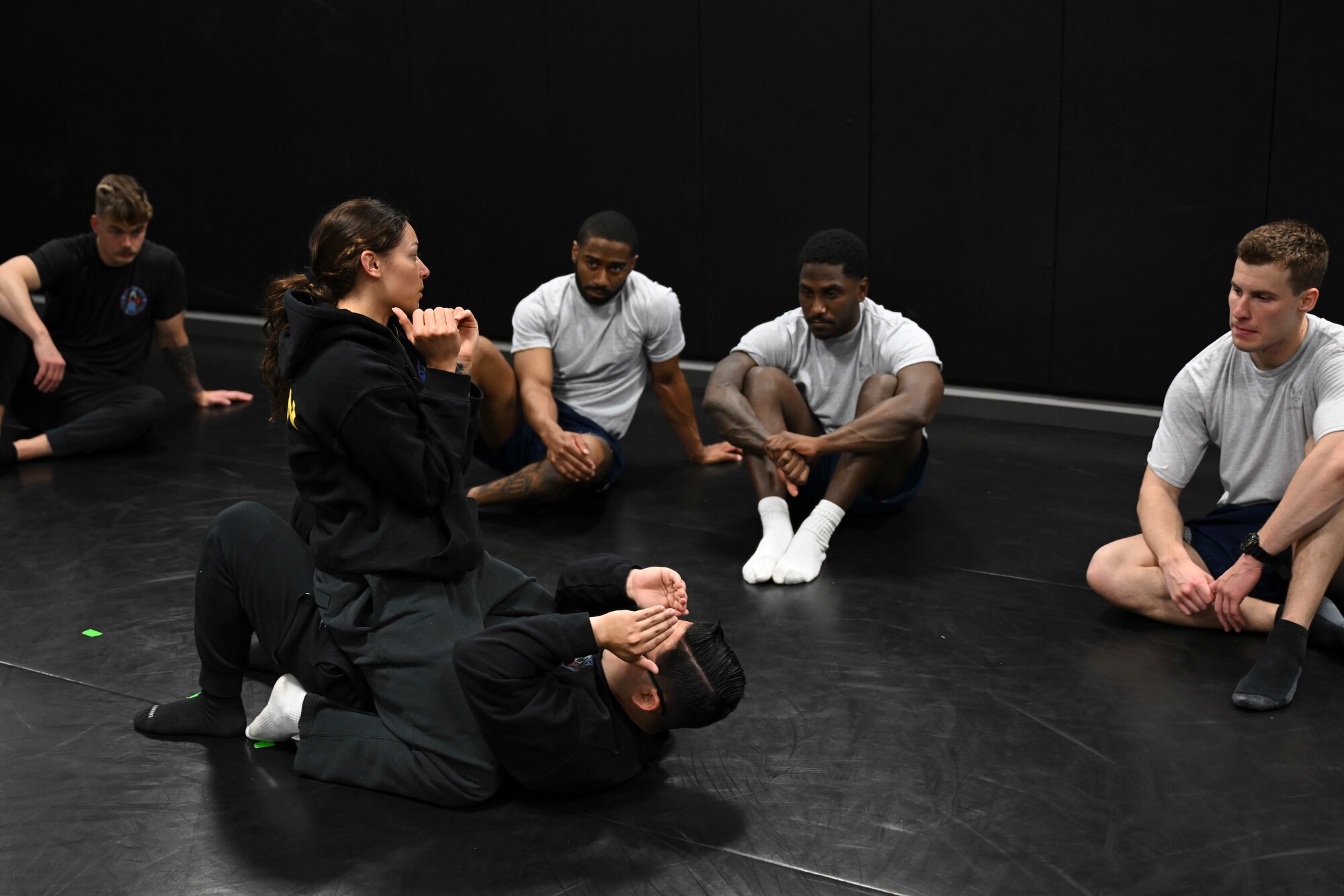 Phoenix Raven candidates observe a combatives demonstration during the Pre-Raven course at Joint Base Andrews, Md., April 14, 2025. Instructors taught defensive techniques to help candidates build the confidence and skills necessary for high-risk missions abroad. (U.S. Air Force photo by Senior Airman Gianluca Ciccopiedi)