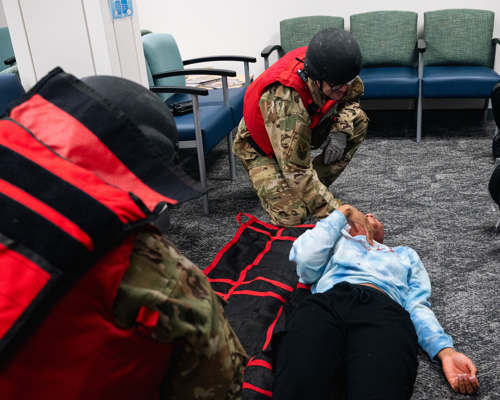 Two people assess an injured person.