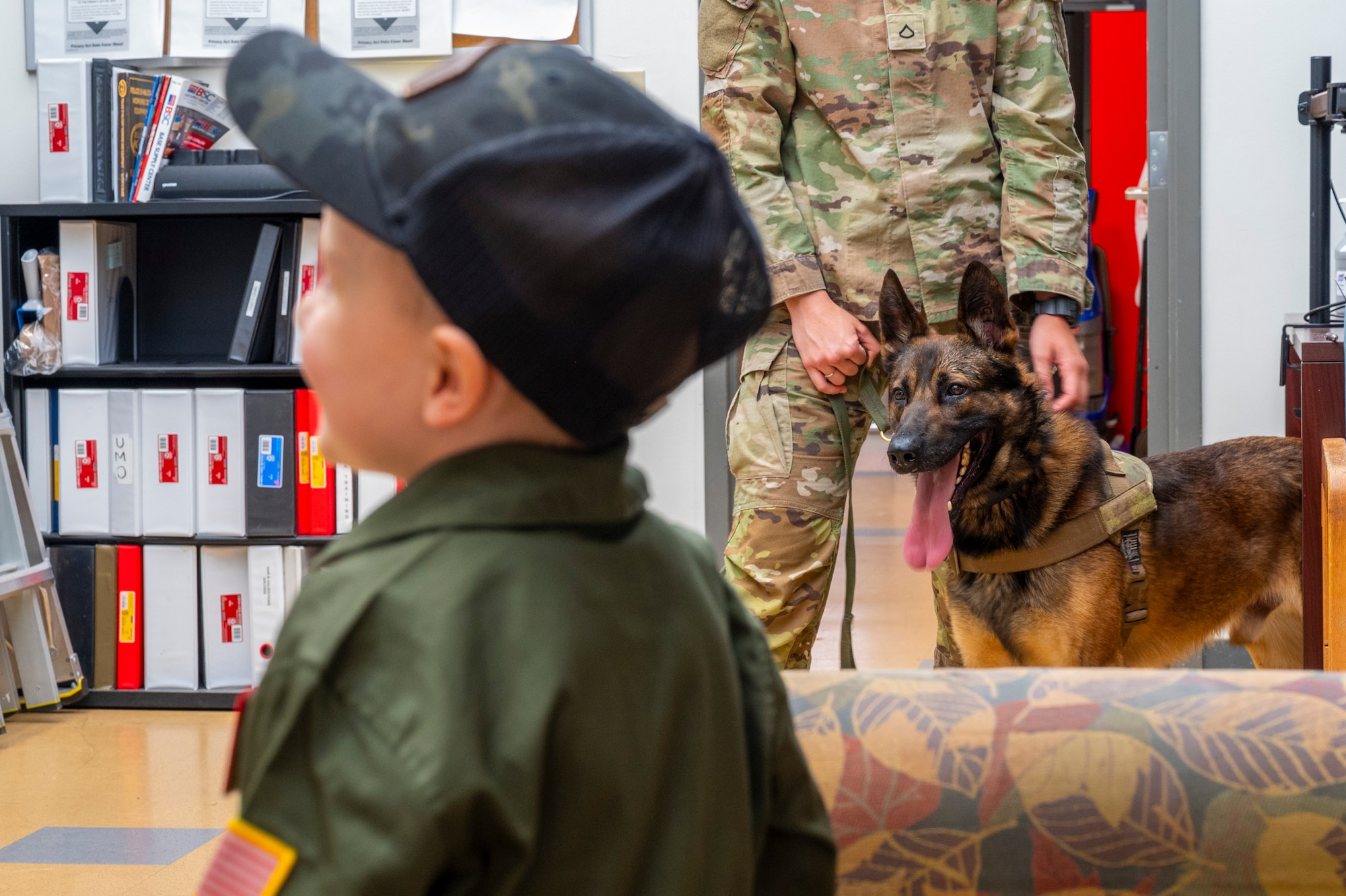 Benny Blankenship, the 2025 Team McChord pilot for a day, listens to working dog handlers at Joint Base Lewis-McChord, Washington, April 17, 2025.