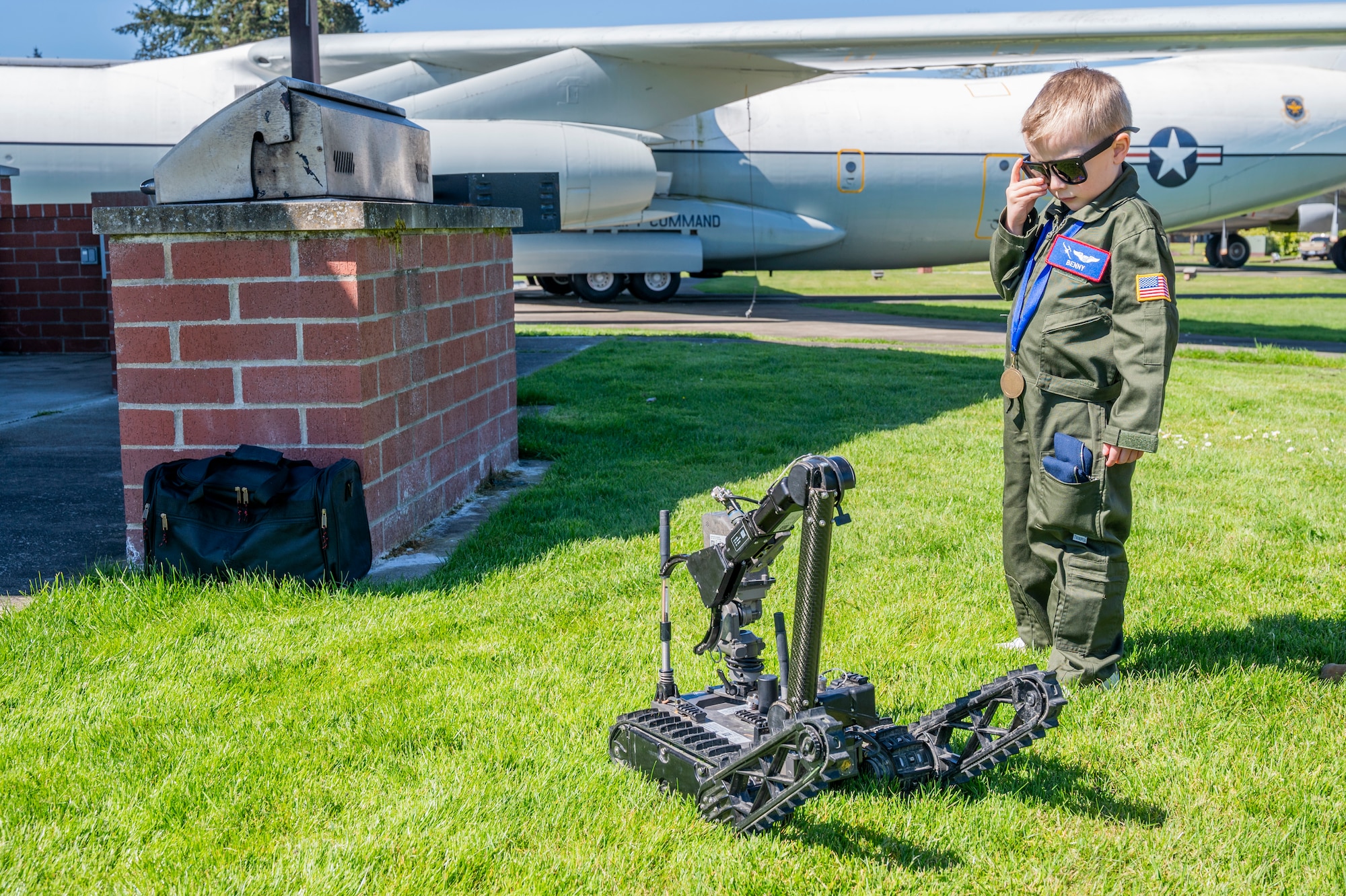 Benny Blankenship, the 2025 Team McChord pilot for a day, watches an explosive ordnance disposal robot reposition itself at Joint Base Lewis-McChord, Washington, April 17, 2025.