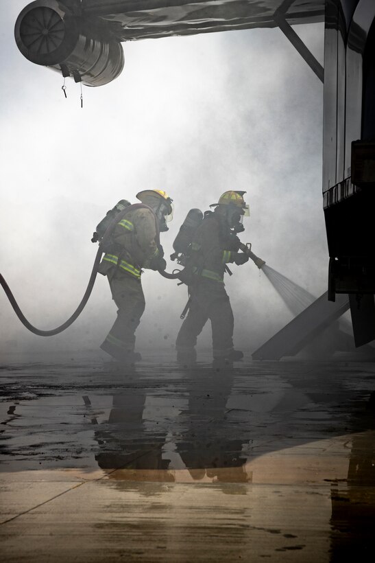 U.S. Marines with Marine Wing Support Squadron 471, Marine Aircraft Group 41, 4th Marine Aircraft Wing, respond to a simulated aircraft fire during a Base Recovery After Attack as part of Integrated Training Exercise 4-24 at Camp Wilson, Marine Corps Air-Ground Combat Center, Twentynine Palms, California, June 22, 2024. The purpose of this simulation is to maintain readiness by demonstrating the ability to rapidly restore an airfield to operational capability following a simulated attack. ITX enables Marine Forces Reserve to mobilize geographically dispersed forces for potential future deployments, increase combat readiness and lethality, and exercise Marine Air-Ground Task Force command and control of battalions and squadrons across the full spectrum of warfare. (U.S. Marine Corps photo by Cpl. Hunter Wagner)