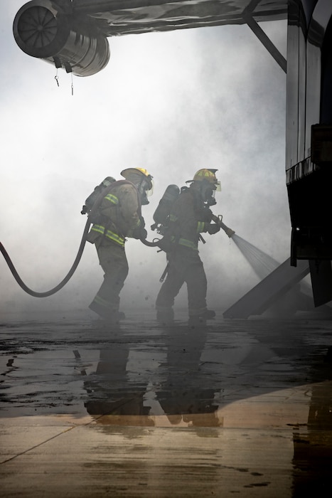 U.S. Marines with Marine Wing Support Squadron 471, Marine Aircraft Group 41, 4th Marine Aircraft Wing, respond to a simulated aircraft fire during a Base Recovery After Attack as part of Integrated Training Exercise 4-24 at Camp Wilson, Marine Corps Air-Ground Combat Center, Twentynine Palms, California, June 22, 2024. The purpose of this simulation is to maintain readiness by demonstrating the ability to rapidly restore an airfield to operational capability following a simulated attack. ITX enables Marine Forces Reserve to mobilize geographically dispersed forces for potential future deployments, increase combat readiness and lethality, and exercise Marine Air-Ground Task Force command and control of battalions and squadrons across the full spectrum of warfare. (U.S. Marine Corps photo by Cpl. Hunter Wagner)