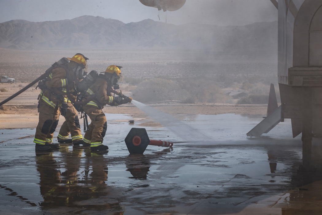 U.S. Marines with Marine Wing Support Squadron 471, Marine Aircraft Group 41, 4th Marine Aircraft Wing, respond to a simulated aircraft fire during a Base Recovery After Attack as part of Integrated Training Exercise 4-24 at Camp Wilson, Marine Corps Air-Ground Combat Center, Twentynine Palms, California, June 22, 2024. The purpose of this simulation is to maintain readiness by demonstrating the ability to rapidly restore an airfield to operational capability following a simulated attack. ITX enables Marine Forces Reserve to mobilize geographically dispersed forces for potential future deployments, increase combat readiness and lethality, and exercise Marine Air-Ground Task Force command and control of battalions and squadrons across the full spectrum of warfare. (U.S. Marine Corps photo by Cpl. Hunter Wagner)