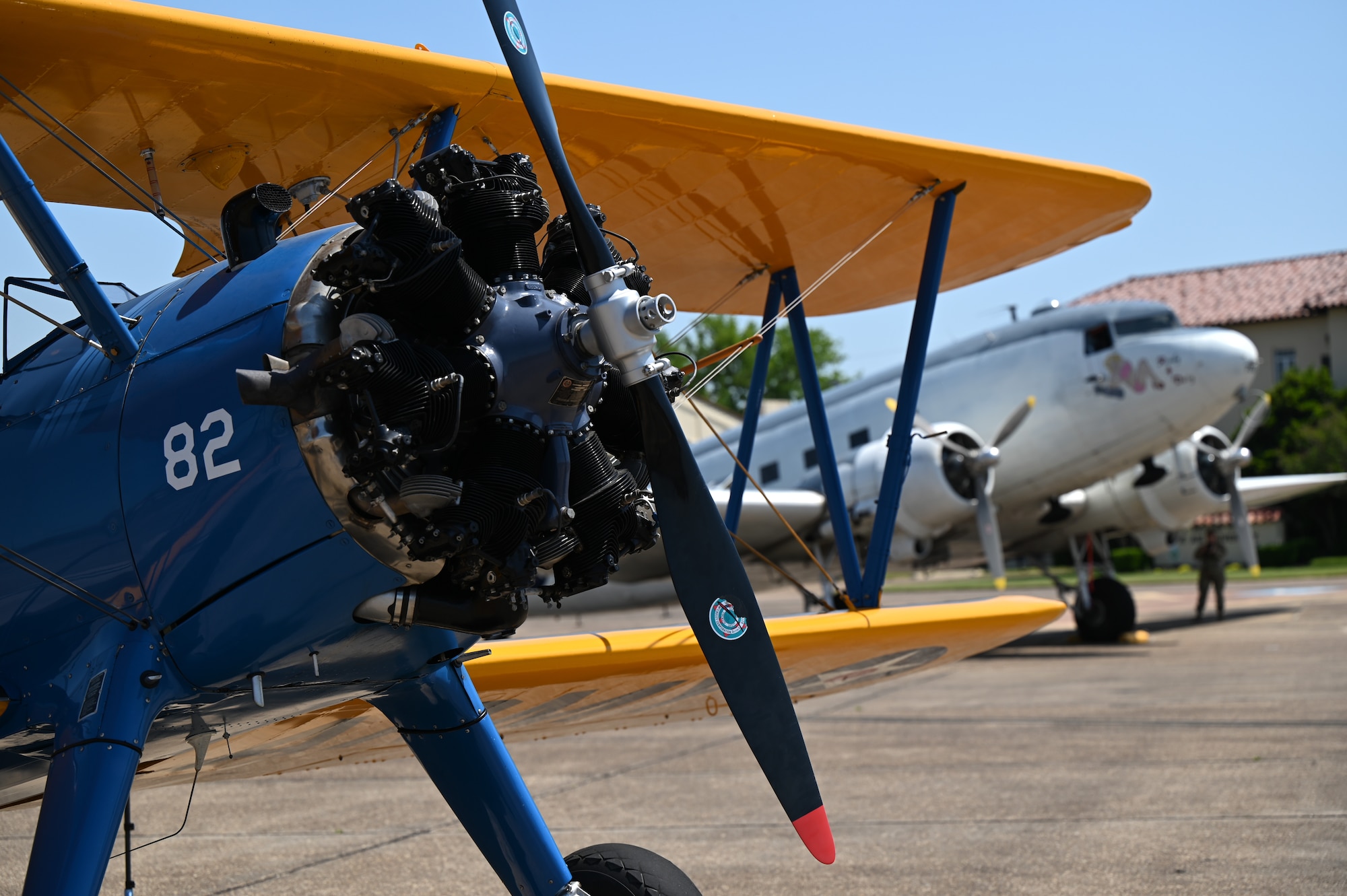 A Commemorative Air Force PT-17 Stearman, left, and a CAF “Ready 4 Duty” Douglas R4D-6S, right, are parked on the flight line at Maxwell Air Force Base, Alabama, April 17, 2025.