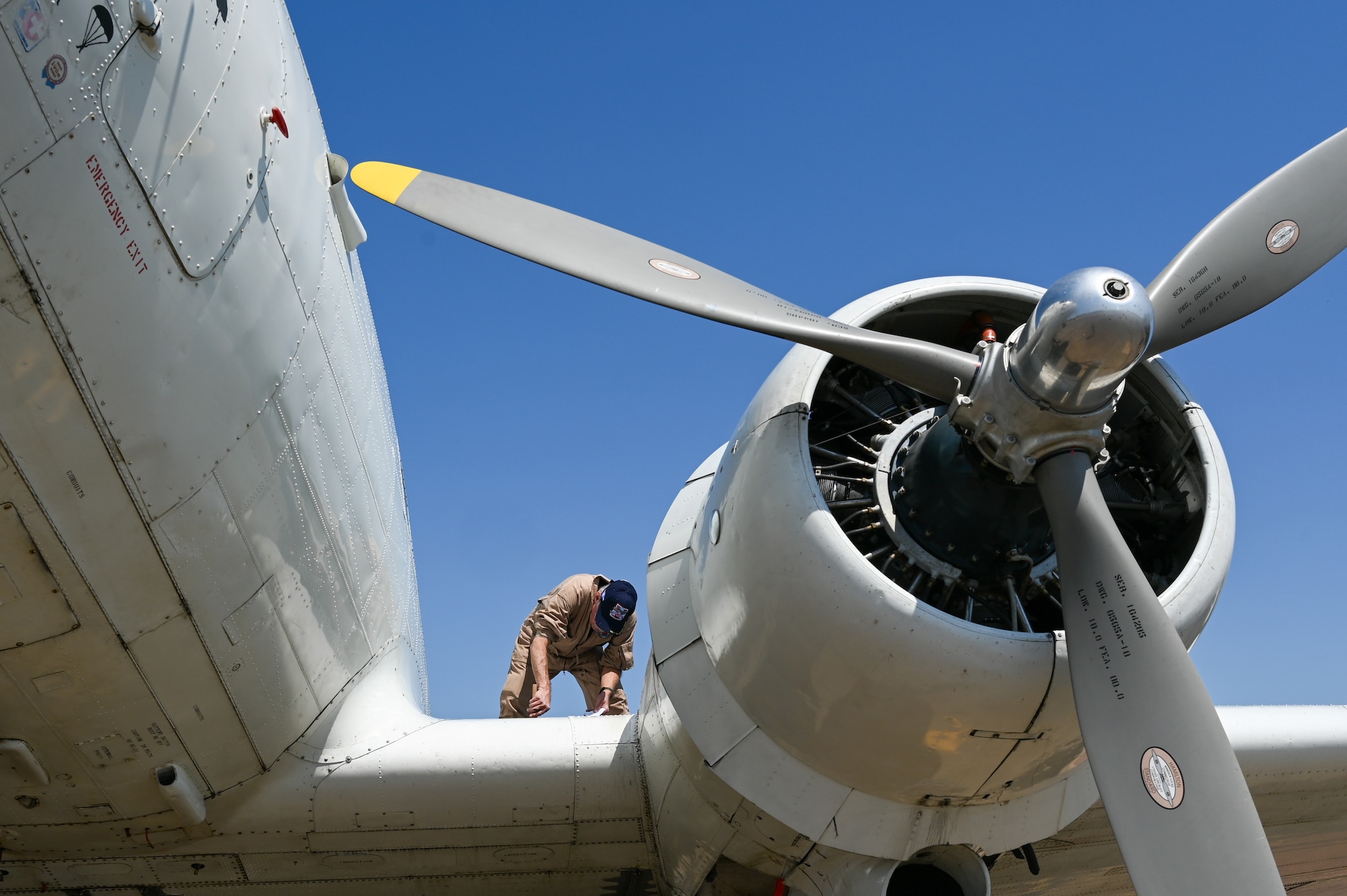 Robert Collier, Commemorative Air Force crew chief, checks the oil on the CAF “Ready 4 Duty” Douglas R4D-6S at Maxwell Air Force Base, Alabama, April 17, 2025.