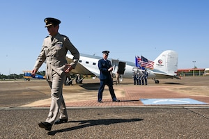 Royal Air Force Group Capt. Tim Brookes, Air War College, left, and U.S. Air Force Lt. Col. Matt Ziemann, Air Command and Staff College Department of Leadership instructor, right, walk on the flight line at Maxwell Air Force Base, Alabama, April 17, 2025.