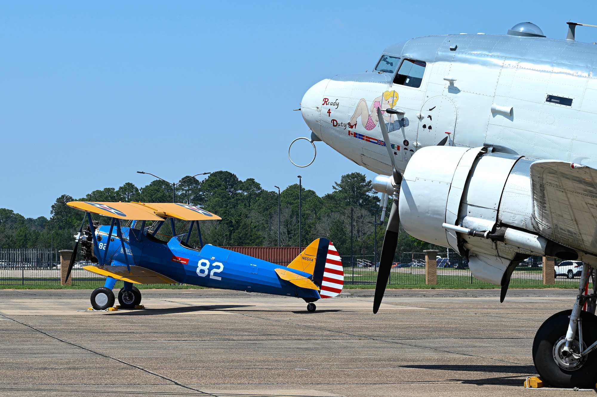 A Commemorative Air Force PT-17 Stearman, left, and a CAF “Ready 4 Duty” Douglas R4D-6S, right, are parked on the flight line at Maxwell Air Force Base, Alabama, April 17, 2025.