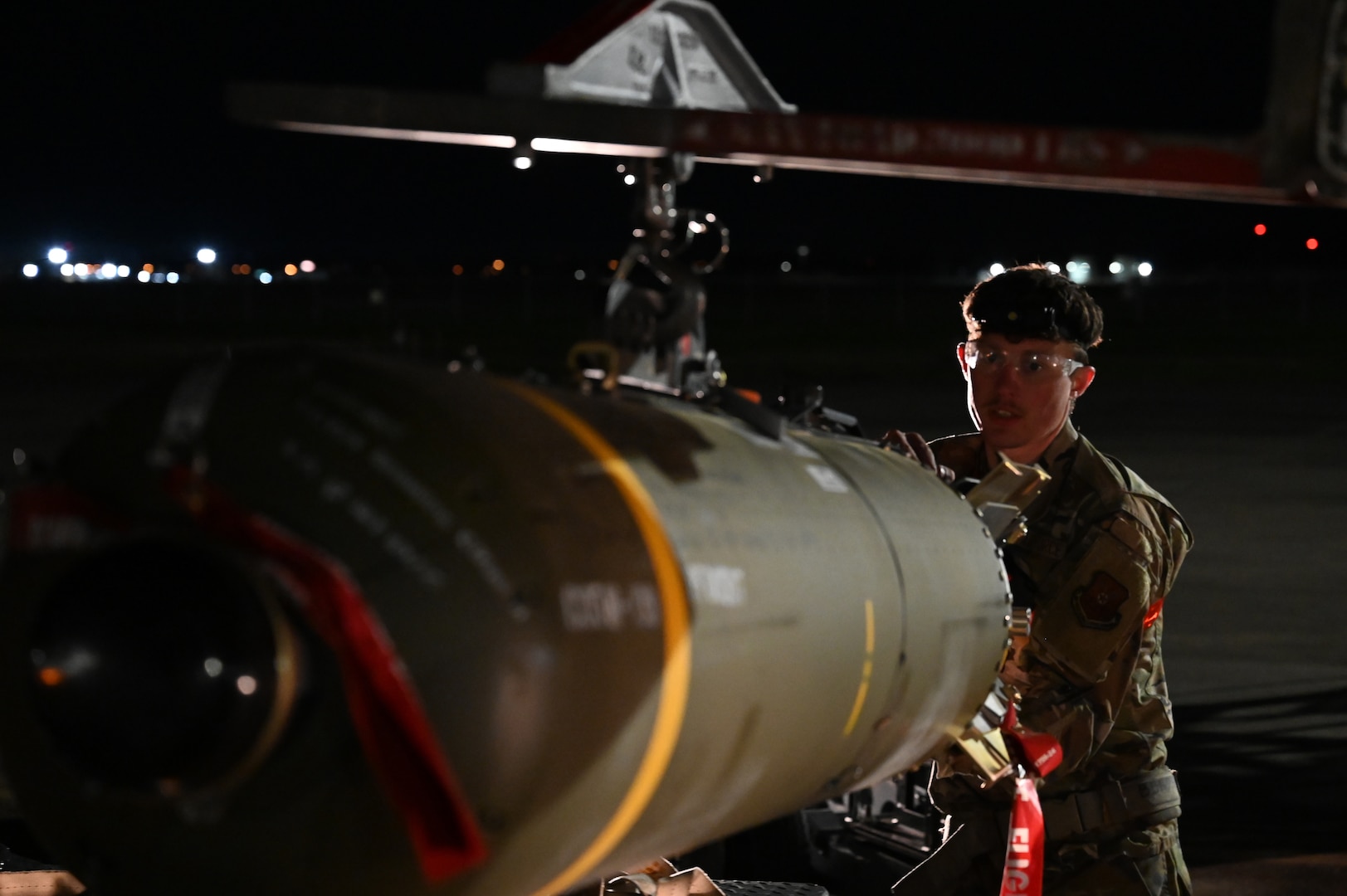 U.S. Air Force Airman 1st Class Kaden Brewer, 96th Bomb Squadron weapons load crew member, transfers a CBU-105, or cluster bomb unit, from a munitions trailer to a MJ-1 “jammer” for loading onto a B-52H Stratofortress
