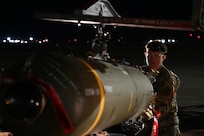 U.S. Air Force Airman 1st Class Kaden Brewer, 96th Bomb Squadron weapons load crew member, transfers a CBU-105, or cluster bomb unit, from a munitions trailer to a MJ-1 “jammer” for loading onto a B-52H Stratofortress