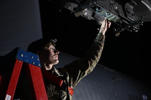 Airman 1st Class Kaden Brewer, 96th Bomb Squadron weapons load crew member, removes cart retainers from breaches