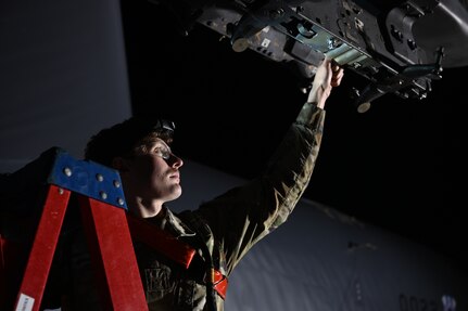 Airman 1st Class Kaden Brewer, 96th Bomb Squadron weapons load crew member, removes cart retainers from breaches
