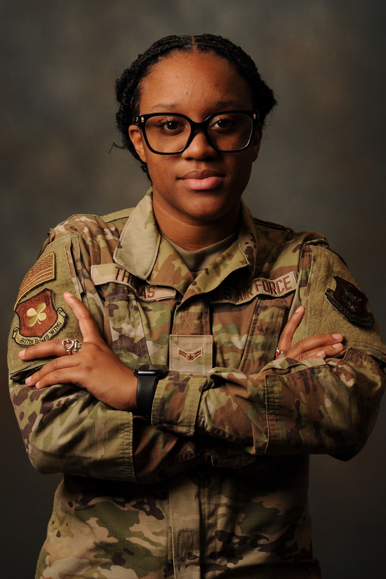 An Airman poses for photo with arms crossed.