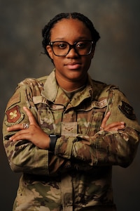 An Airman poses for photo with arms crossed.